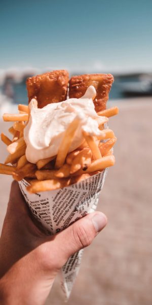Delicious fish and chips served in a newspaper cone, perfect summer beach food.